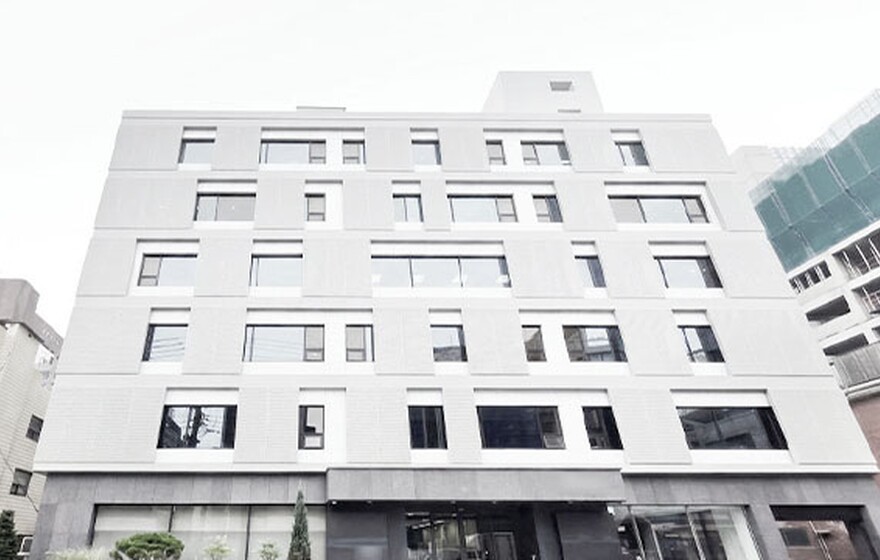 Zyxel Nebula case study: a modern multi-story office building with a grey-textured facade and asymmetrical windows in Korea.